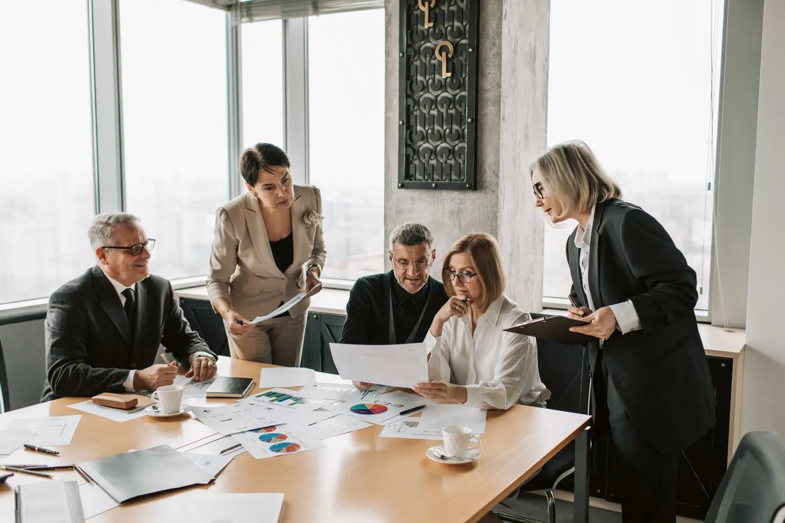Business professionals reviewing documents for dispute advisory